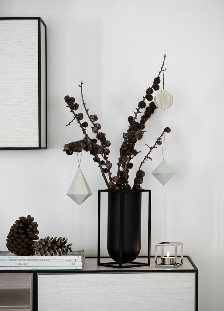 Holiday Decoration - ornaments and pine cones on living room stand